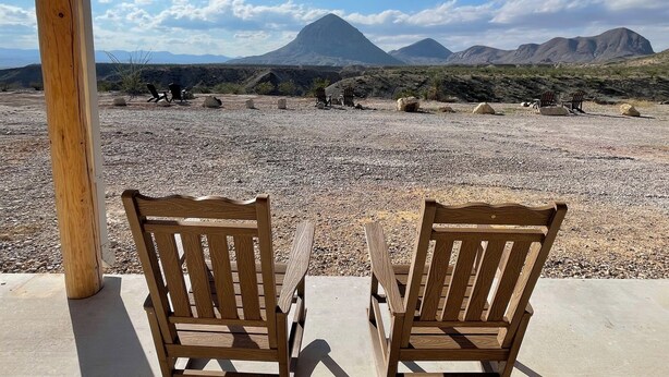 Two wooden chairs facing a rocky landscape with mountains in the background. - Ten Bits Ranch - Room #19 Lewis Land & Cattle Co. (Terlingua)