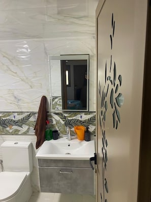 Shower, towels, soap, toilet paper