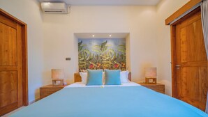 A bedroom with a large bed, wooden headboard, and a tropical mural on the wall. - Luxury Balinese style villa with AC in Seminyak- 5BR for ultimate relaxation (Bali)