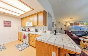 Fridge, dishwasher, coffee/tea maker, cookware/dishes/utensils