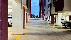A multi-level parking garage with concrete floors and yellow directional arrows. - Classy One bed airbnb by Miss Omuts,pool (Nairobi)
