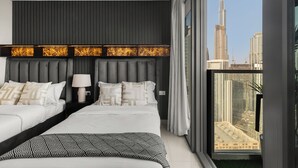 A modern hotel room with a large bed, a headboard with a light panel, and a view of a city skyline. - Gogoto LUX Burj View Spacious (Dubai)