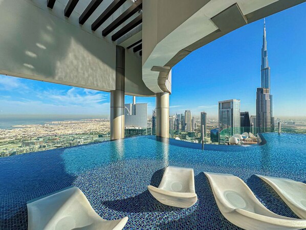 Outdoor pool, open 7:00 AM to 7:00 PM, pool umbrellas, sun loungers