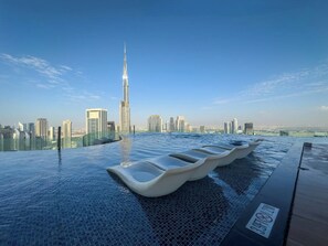 Outdoor pool, open 7:00 AM to 7:00 PM, pool umbrellas, sun loungers - Gogoto LUX Burj View Spacious (Dubai)