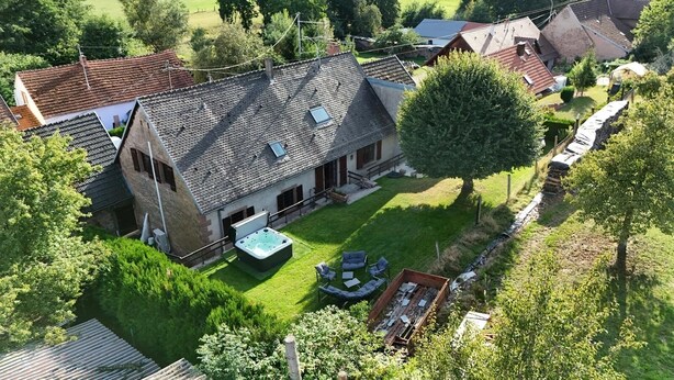 A house with a sloped roof, a hot tub, and a well-maintained lawn. - New home! La Buissonnière, 12 to 14 pers with Spa, 45min from Strasbourg. (Erckartswiller)
