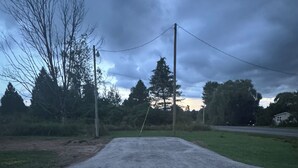 A paved road with a grassy area on one side and trees in the background. - Private campsite in Pulaski for a peaceful get away. (Pulaski)