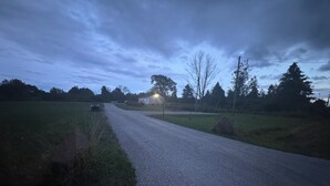 A rural road with a house on the right side. - Private campsite in Pulaski for a peaceful get away. (Pulaski)