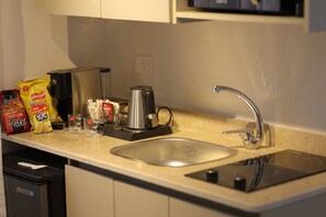 Mini-fridge, microwave, stovetop, cookware/dishes/utensils