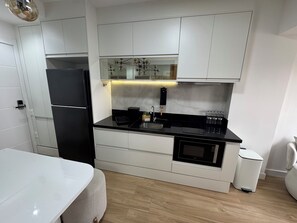 Fridge, microwave, stovetop, coffee/tea maker