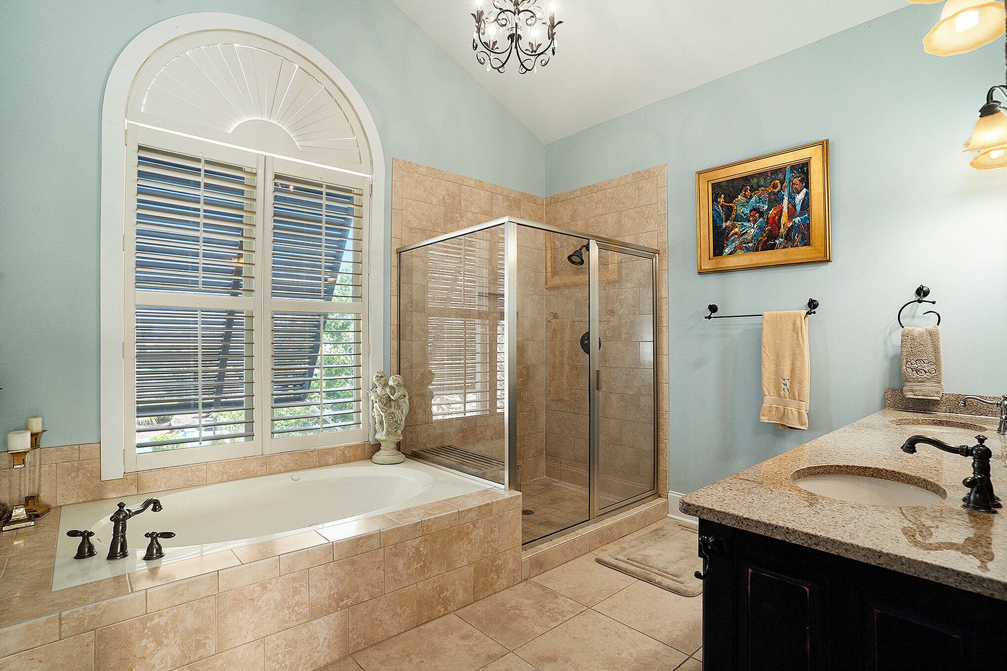 A bathroom with a bathtub, shower, and vanity.