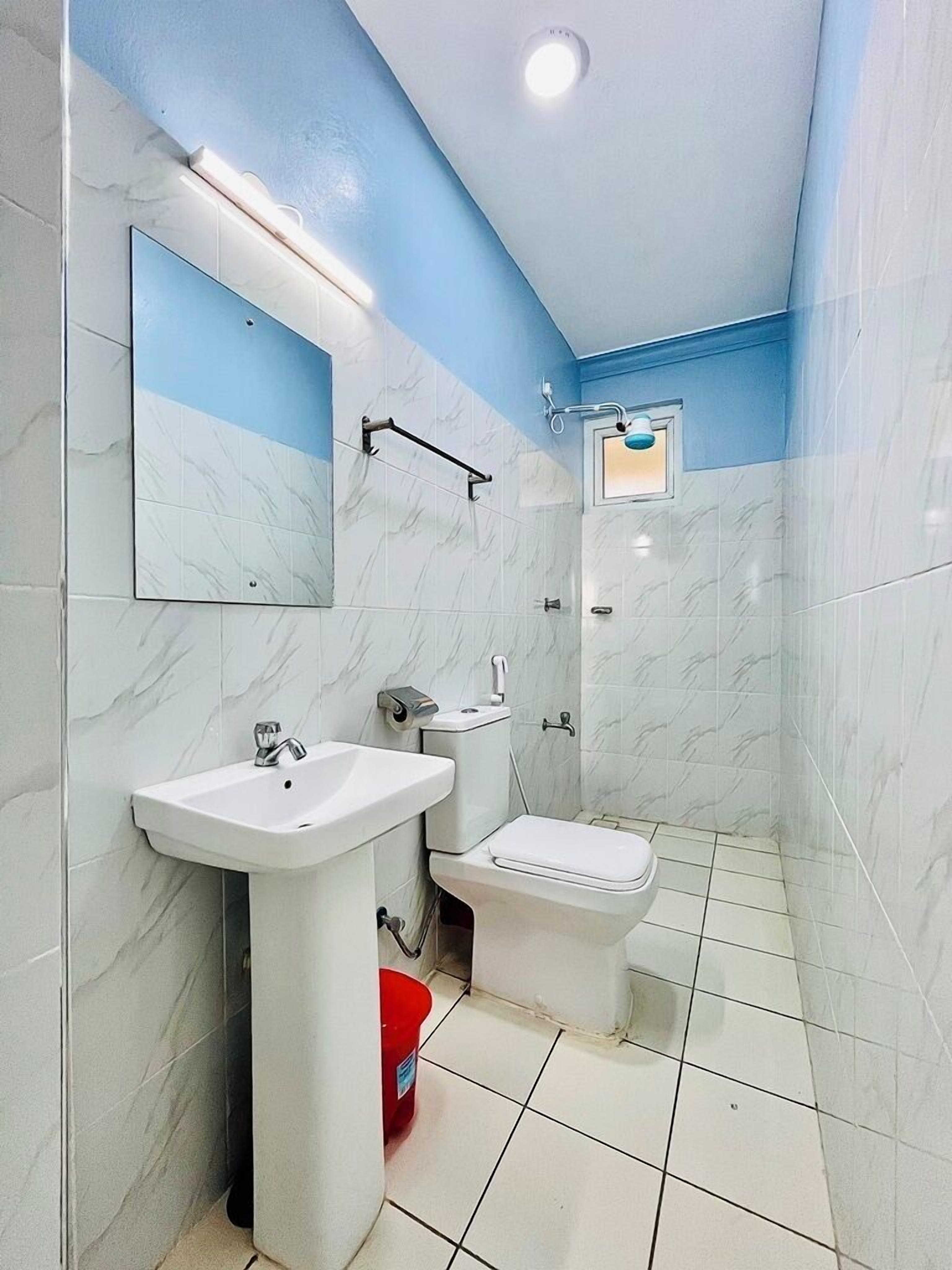 A bathroom with a sink, toilet, and shower.