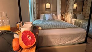A hotel room with a bed, bedside table, and a window with curtains. - One Block Kiawah Beach Villa (Kiawah Island)