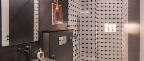 A bathroom with a sink, toilet, and shower.