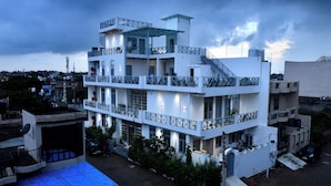 A multi-story building with balconies and a flat roof. - Inara House (Agra)