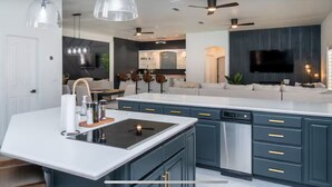 A modern kitchen with a central island, built-in appliances, and pendant lighting. - 4400 SqFt Luxury Estate W/Pool&Spa, Billiards, Entertainment and Comfort (Lake Havasu City)