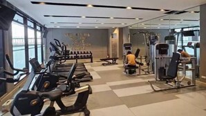 A gym with treadmills, elliptical machines, and weight equipment.