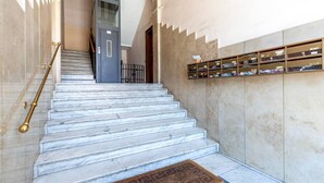 A marble staircase with a handrail, leading to a door. - Perfectly located in the heart of Rome, transportation right outside your door (Roma)