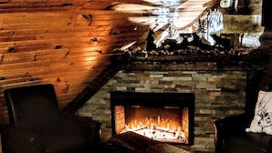 A cozy room with a fireplace, wooden ceiling, and a patterned rug. - Cozy, arts and crafts loft located in the WNC mountains in Black Mtn, NC (Black Mountain)