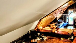 A kitchen with wooden cabinets, a sink, and a countertop with various items. - Cozy, arts and crafts loft located in the WNC mountains in Black Mtn, NC (Black Mountain)