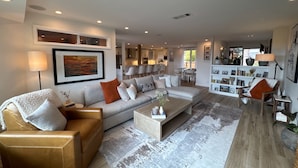 A modern living room with a sofa, coffee table, and a bookshelf. - SLO 2BR/1BA + Bonus Room, Sleeps 6 I Close to Downtown and Cal Poly (San Luis Obispo)