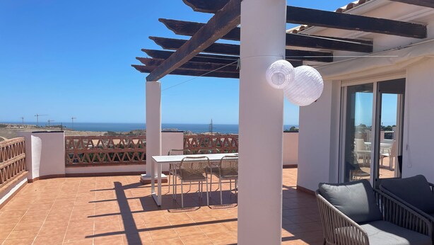 A terrace with a table and chairs, a sofa, and a view of the sea. - Penthouse with exceptionel sea, mountain and golf view over Miraflores golf (AN)