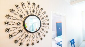 Ein runder Spiegel mit floralem Dekor an der Wand.