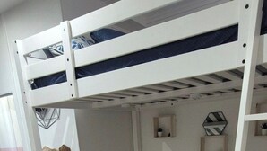 A room with a bunk bed, a sofa, a coffee table, and a small side table. - Pretty Parisian studio (Paris)