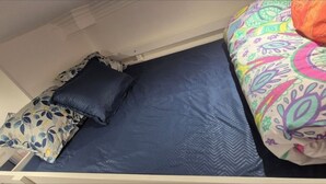 A bunk bed with a blue mattress and patterned bedding. - Pretty Parisian studio (Paris)