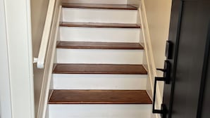 A staircase with white painted walls and wooden steps. - Ryder Cup Rental, 1.4 miles away. 
3-bedroom apartment with parking (Farmingdale)