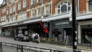 A street view with a row of buildings, including a restaurant named 'CATERERS' with outdoor seating. - in Bournemouth With 2 Bedrooms and 1 Bathrooms (Bournemouth)