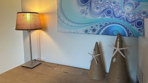 A lamp, two starfish decorations, and a blue abstract painting on a wall. - The Inn at Southern Oaks located in Historic Lavonia, GA, close to Lake Hartwell (Lavonia)
