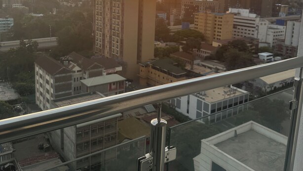 A cityscape with buildings and a sunset. - Stylish| 2 Beds| Fast Wifi| Best Area| (Nairobi)
