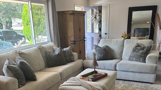 A living room with two sofas, a coffee table, and a large window. - The Loyola – Warm & Welcoming Home Base for Your Pueblo Adventure (Pueblo)