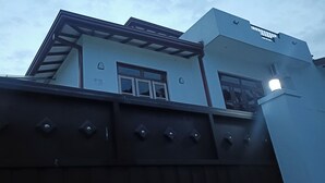 A modern building with a flat roof, large windows, and a gated entrance. - Sweet Home Ja-Ela (Ja-Ela)
