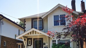 A two-story house with a front porch, a garage, and a driveway.