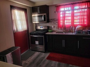 Family Apartment, Garden View | Private kitchen | Fridge, microwave, stovetop, cookware/dishes/utensils