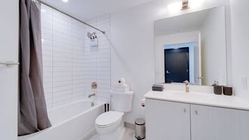 Ein modernes Badezimmer mit Badewanne, Toilette und Waschbecken.