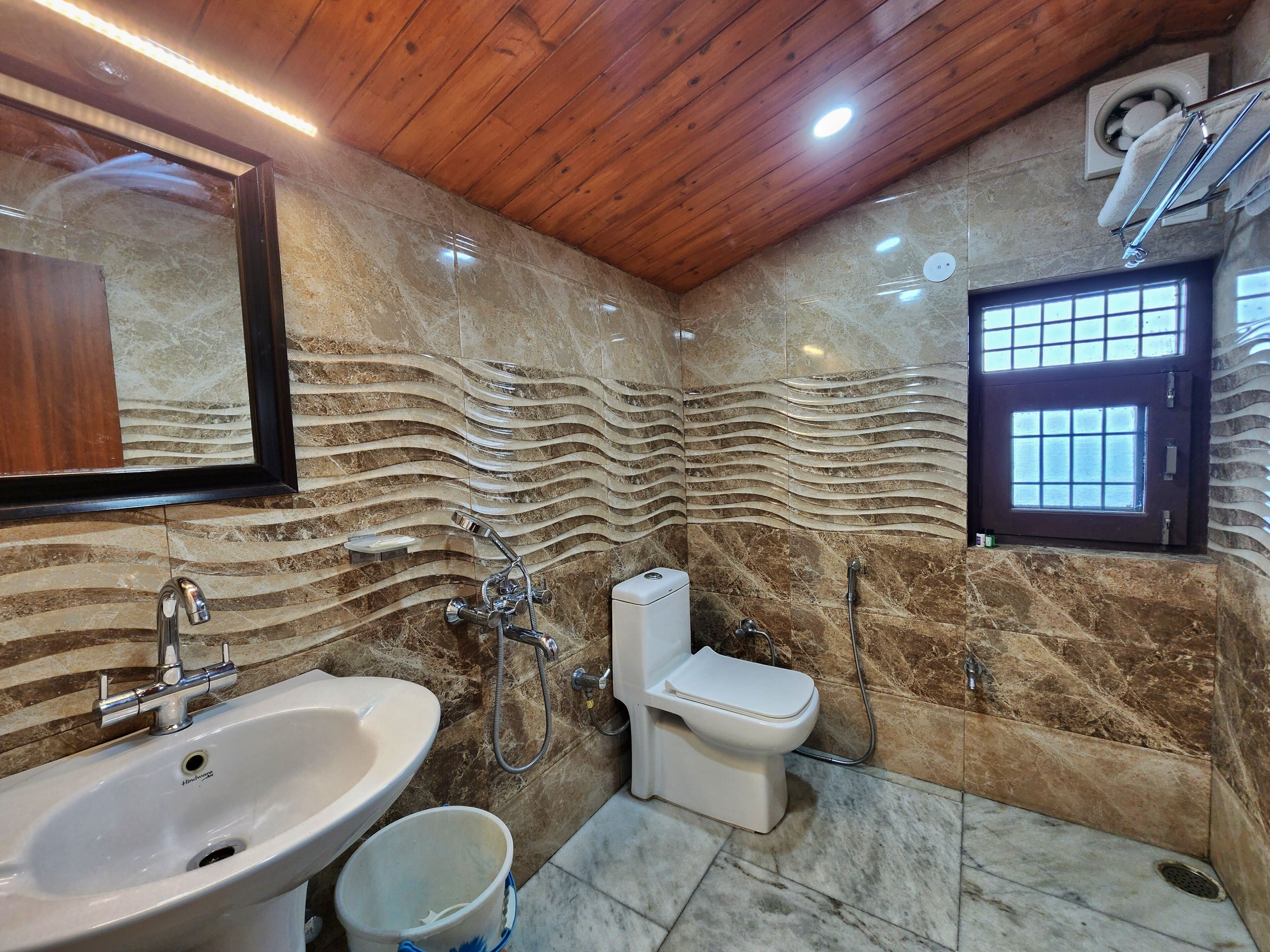 A bathroom with a sink, toilet, and shower.