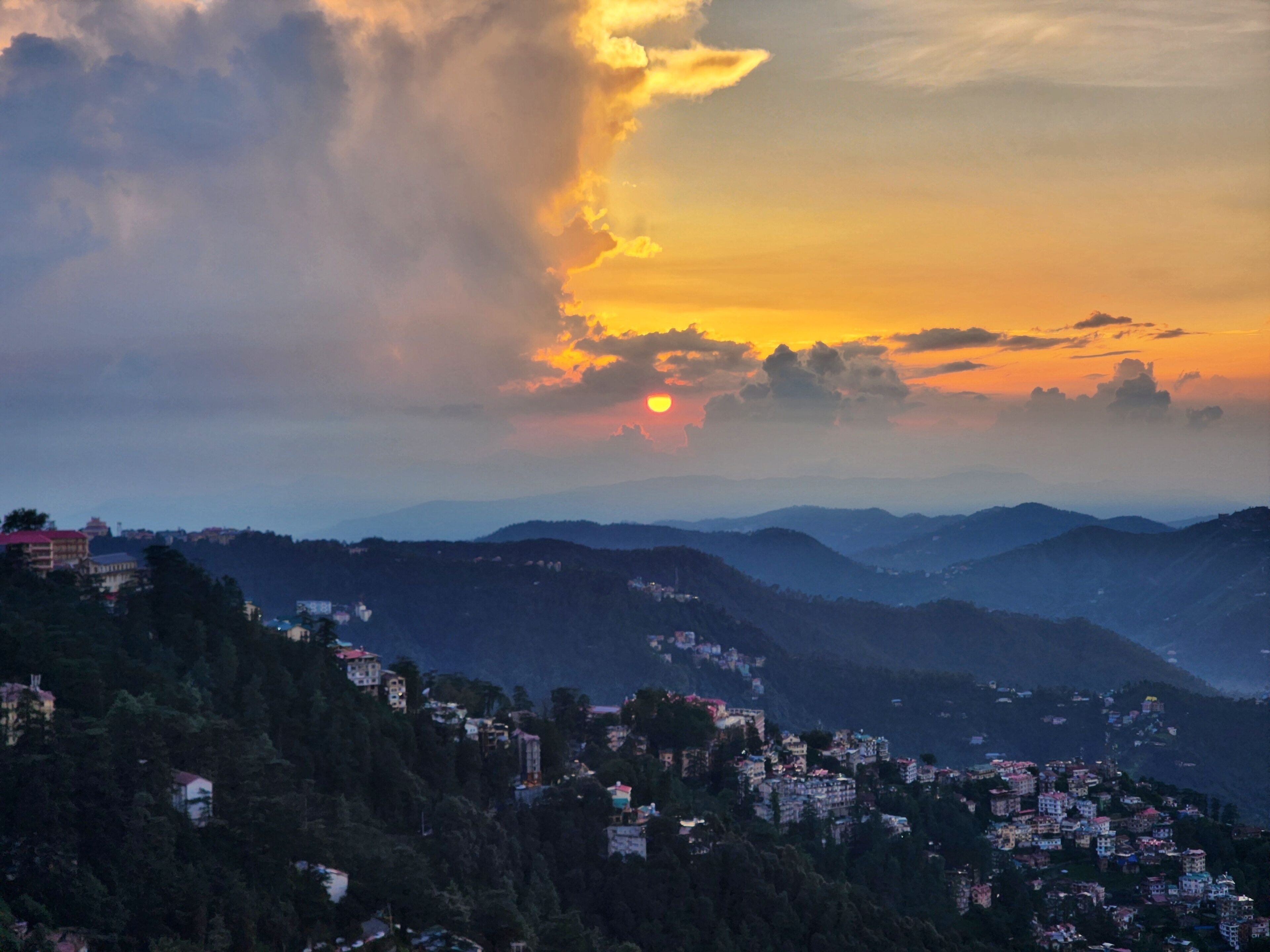 A mountainous landscape with a sunset.