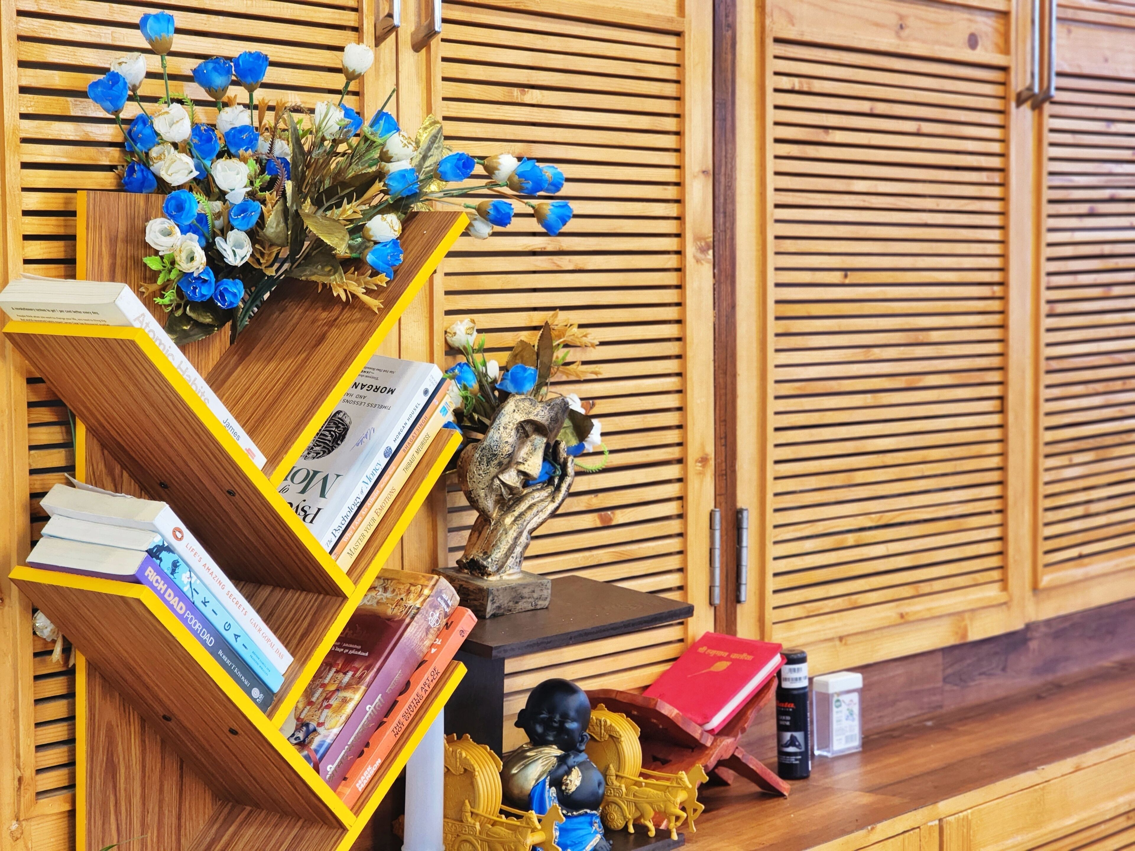 A wooden bookshelf with books and decorative items.