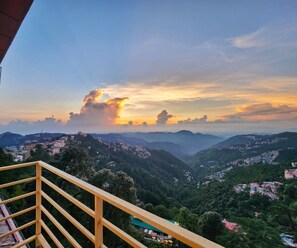 A mountainous landscape with a sunset. - Florence BnB Shimla | Stay Near Mall Road and Ridge (Shimla)