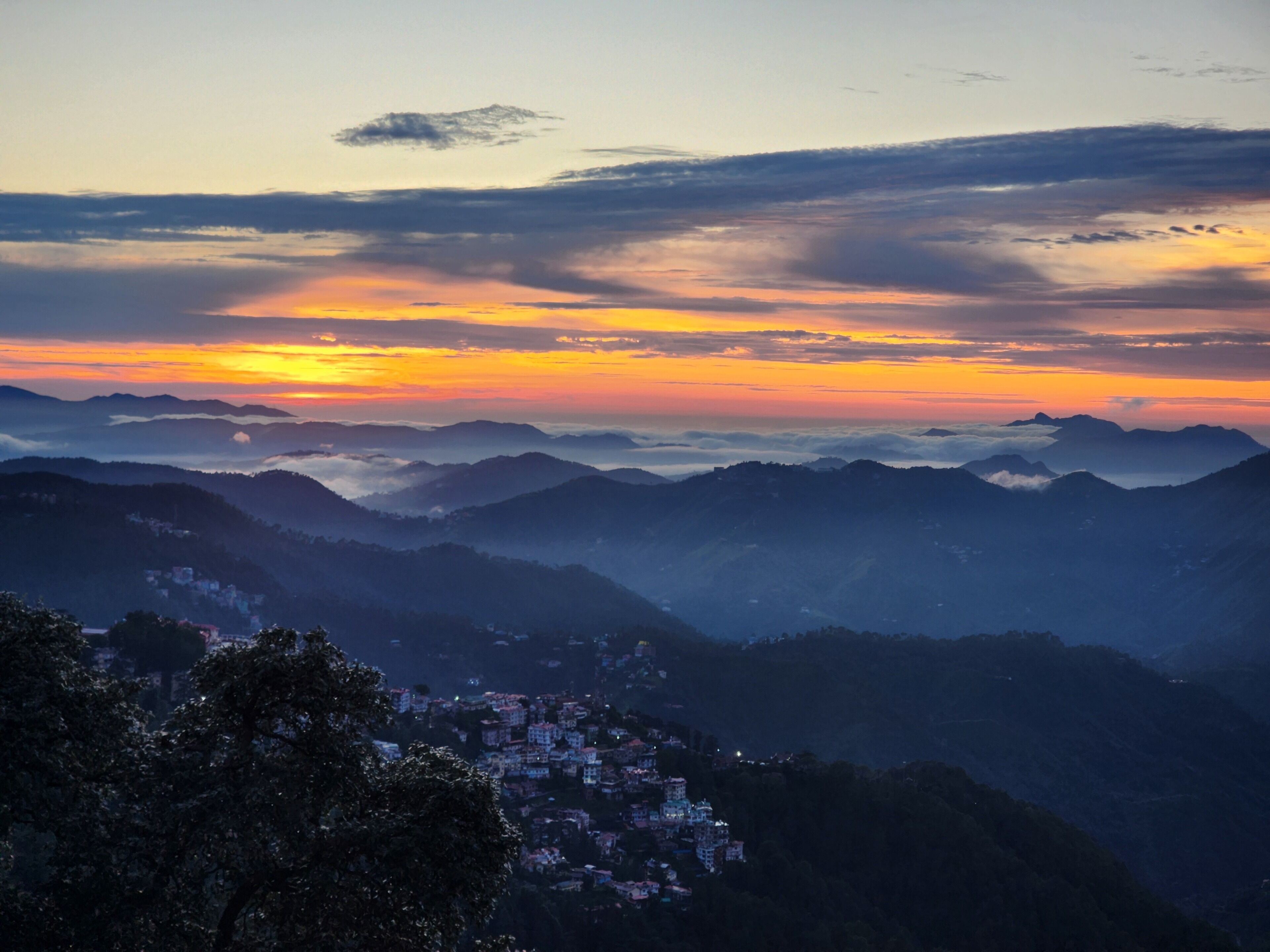A mountainous landscape with a village nestled in the valley.