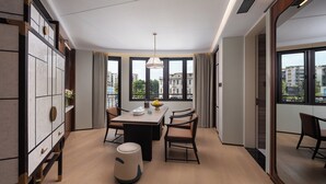 A modern dining area with a table, chairs, and a decorative vase. - Shantou DIOTEL Queen Hotel (Shantou)
