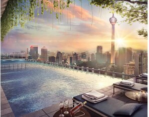 A rooftop pool area with a cityscape view, a lounge with seating, and a tower in the background. - Ceylonz Suites by Icefly Hom's (Kuala Lumpur)