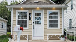 A two-story house with a front porch, a mailbox, and a number 230 sign. - Beautiful Cottage with Water Views - 2 Bedrooms (Delanco)