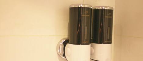 A restroom with two hand dryers mounted on a wall.