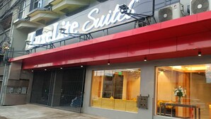 A hotel named "Lite Suites" with a red awning, large windows, and a visible entrance. - LuxeLite Suites Pasay (Pasay)