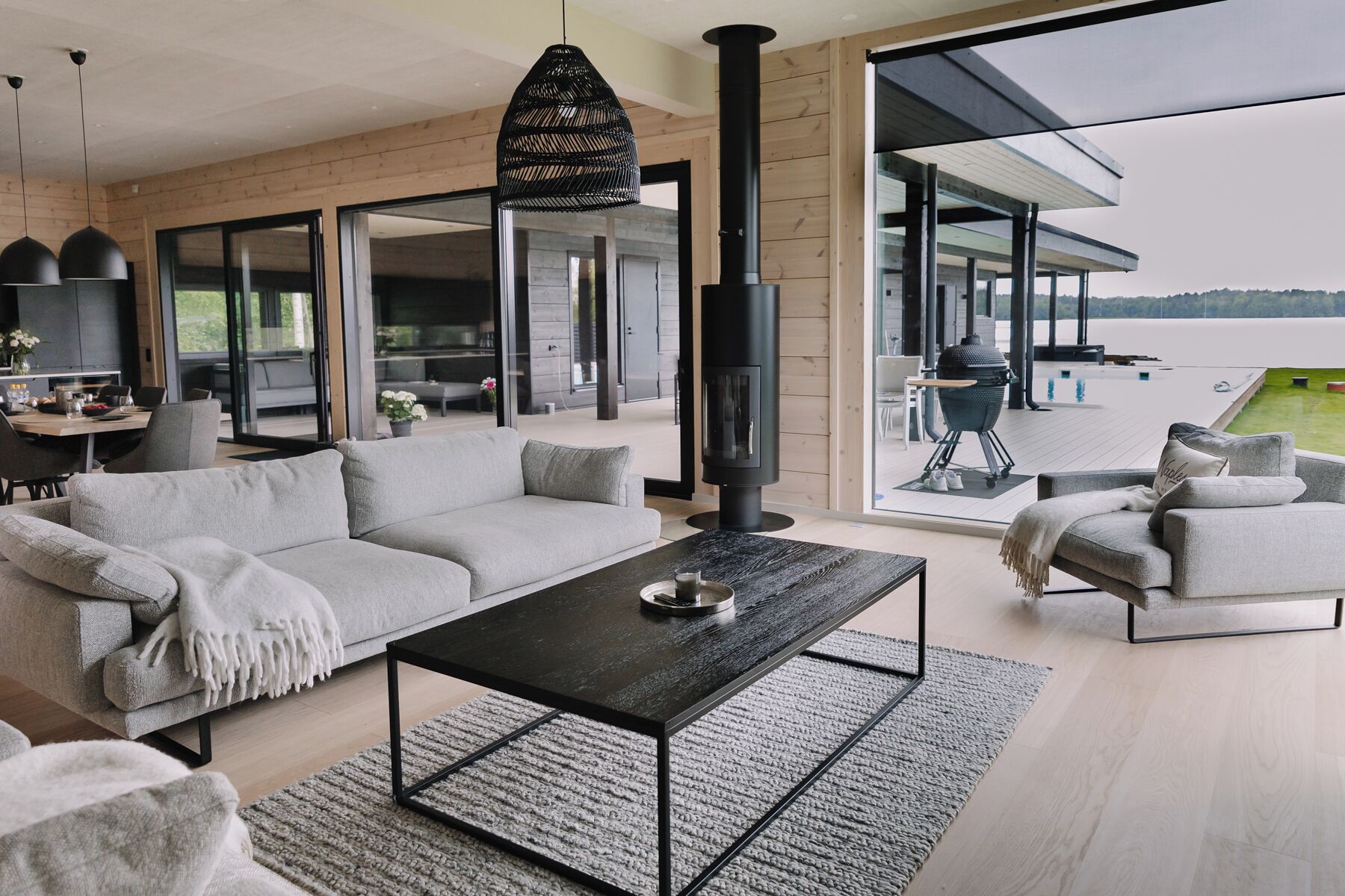 A modern living room with a sofa, coffee table, and a fireplace.