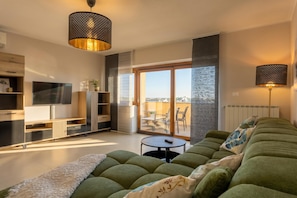 Family Apartment, Multiple Bedrooms (Spacious Apartment Double D) | Living area | 19-inch flat-screen TV with cable channels, fireplace