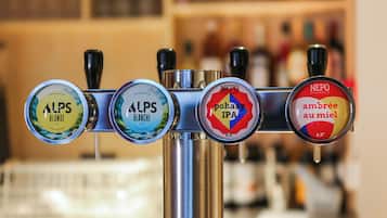 A beer tap with four different beer options: Alps Blonde, Alps Blanche, Pahazy IPA, and Neppo Ambrée au miel.